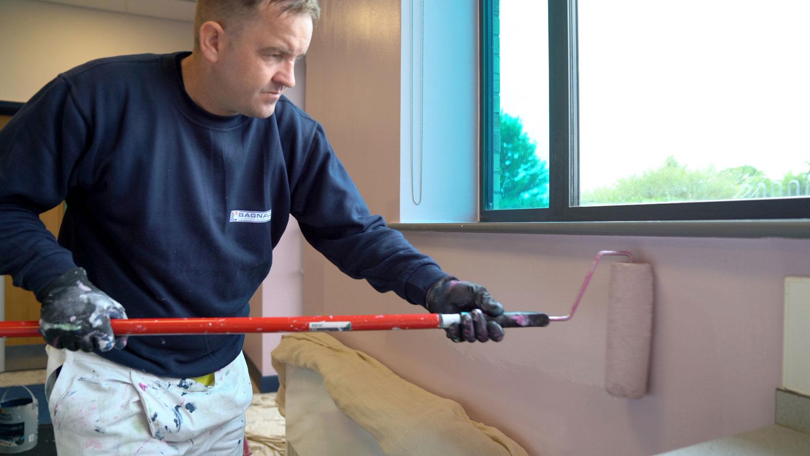 Painter using Dulux Trade paint