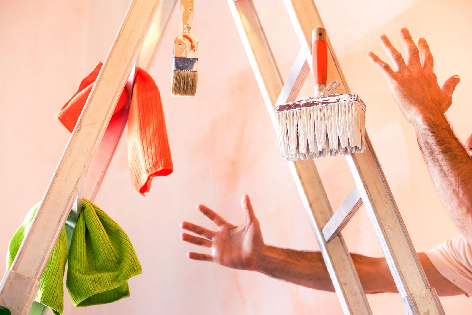 Paintbrushes falling from a stepladder.