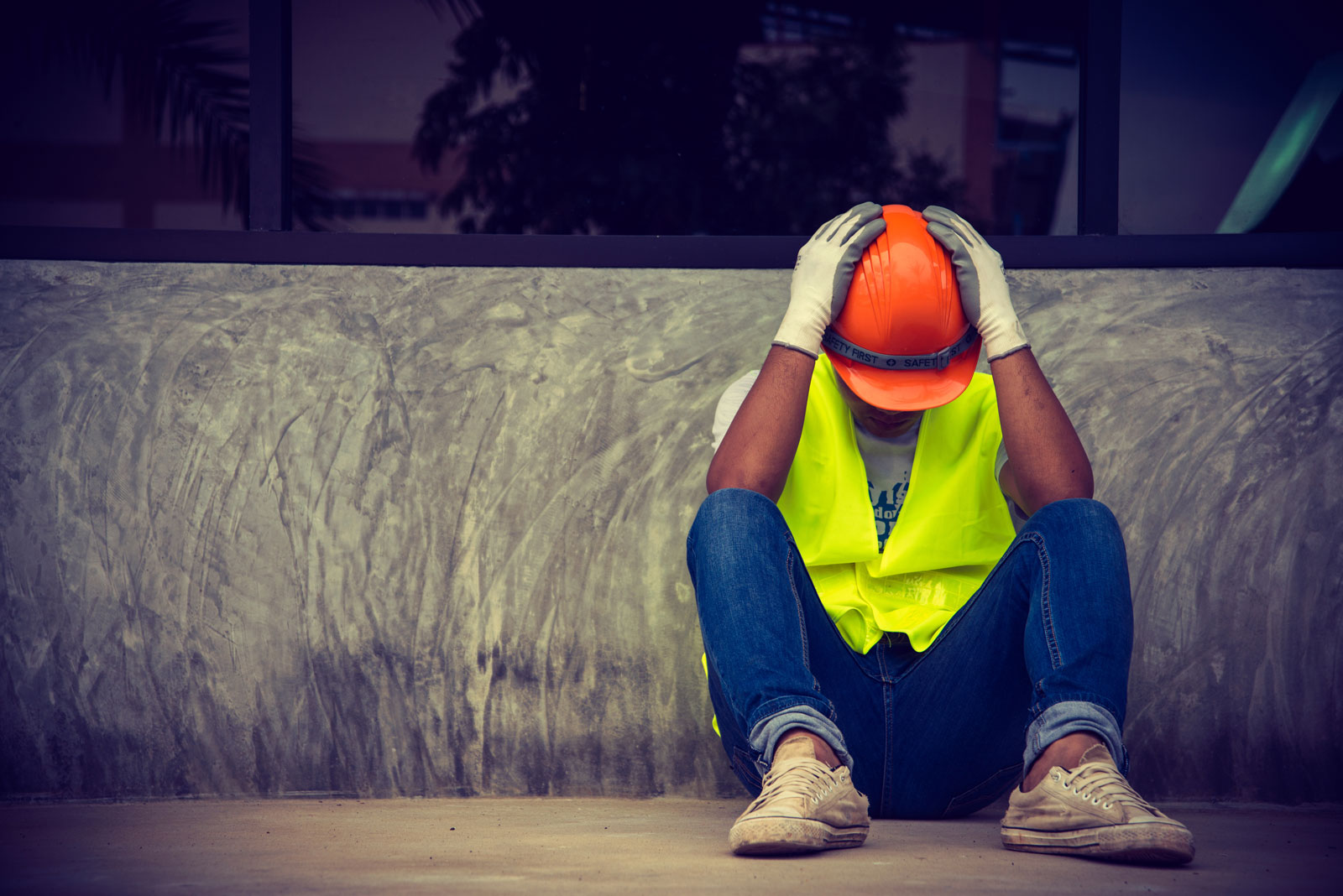 Photograph of a worried man at a construction site
