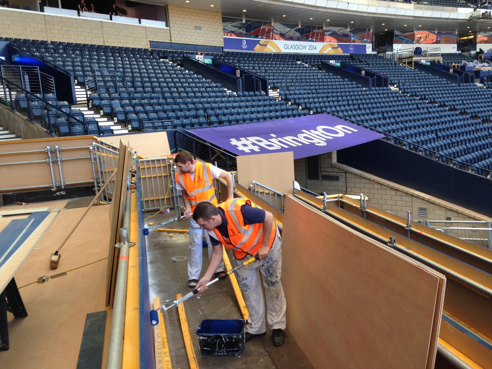 Photograph of painters from Robertson Decorators Ltd painting the Royal Box at Hamden for the Commonwealth Games in 2014