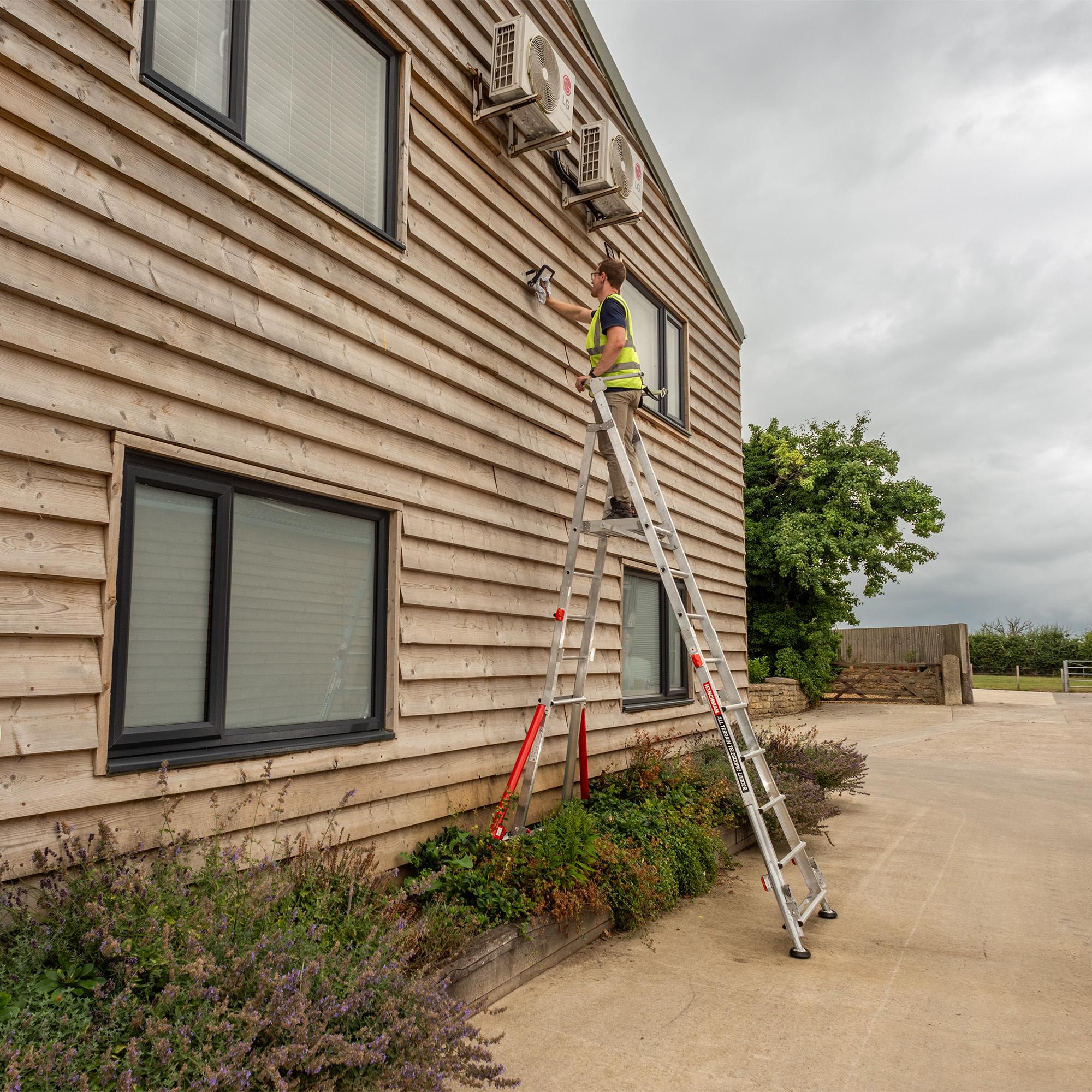 Photograph of a tradesperson working on a ladder.