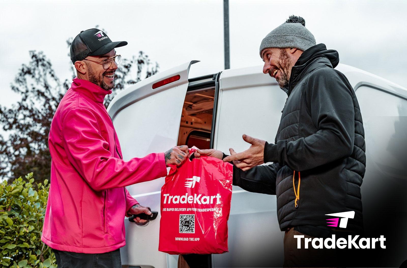 A photograph of a delivery driver handing over a bag of supplies to a contractor.