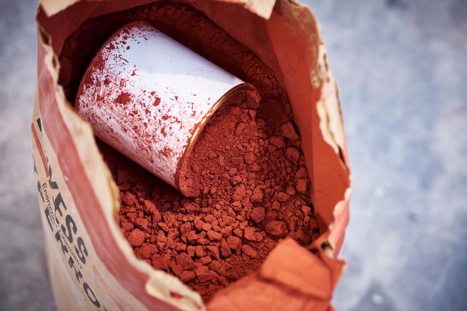 Photograph of natural pigments used to colour paint products.